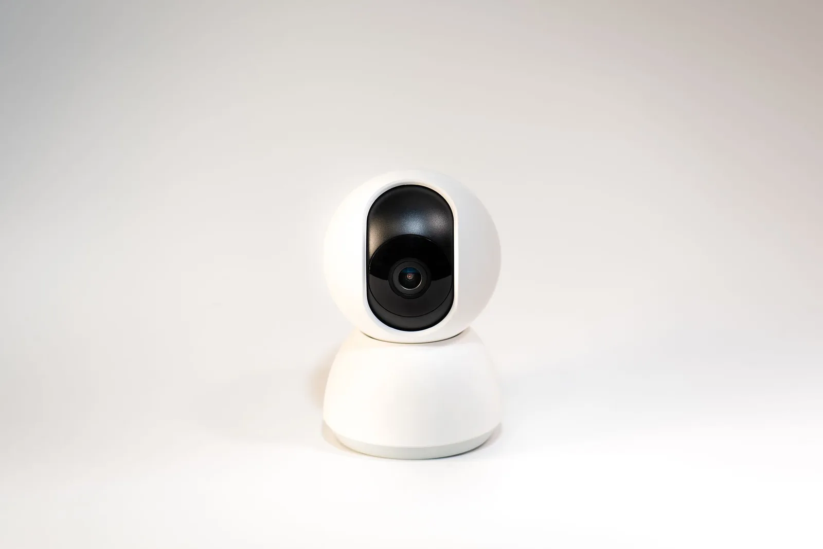 Compact home security camera on neutral background