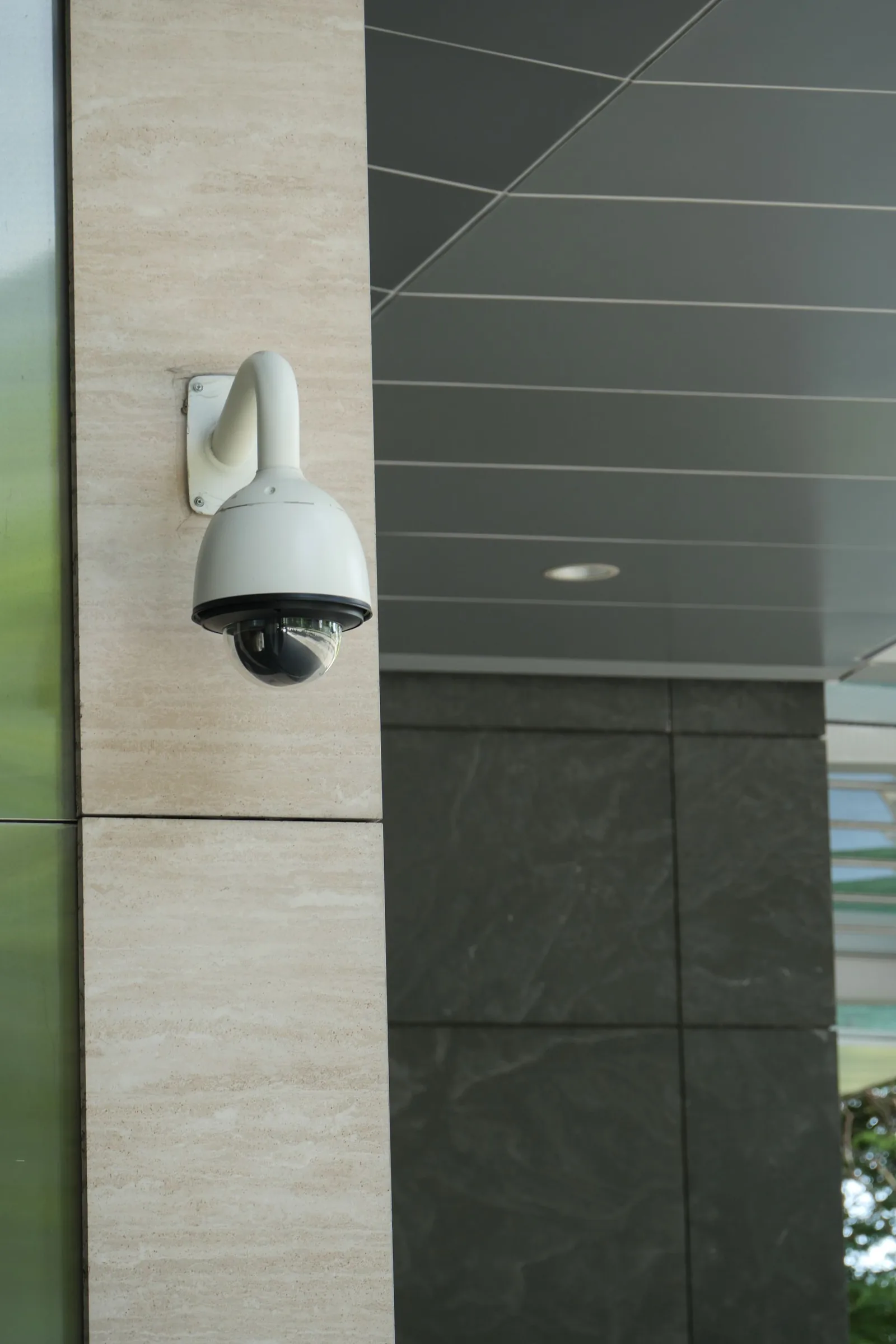 White dome CCTV mounted on a building exterior