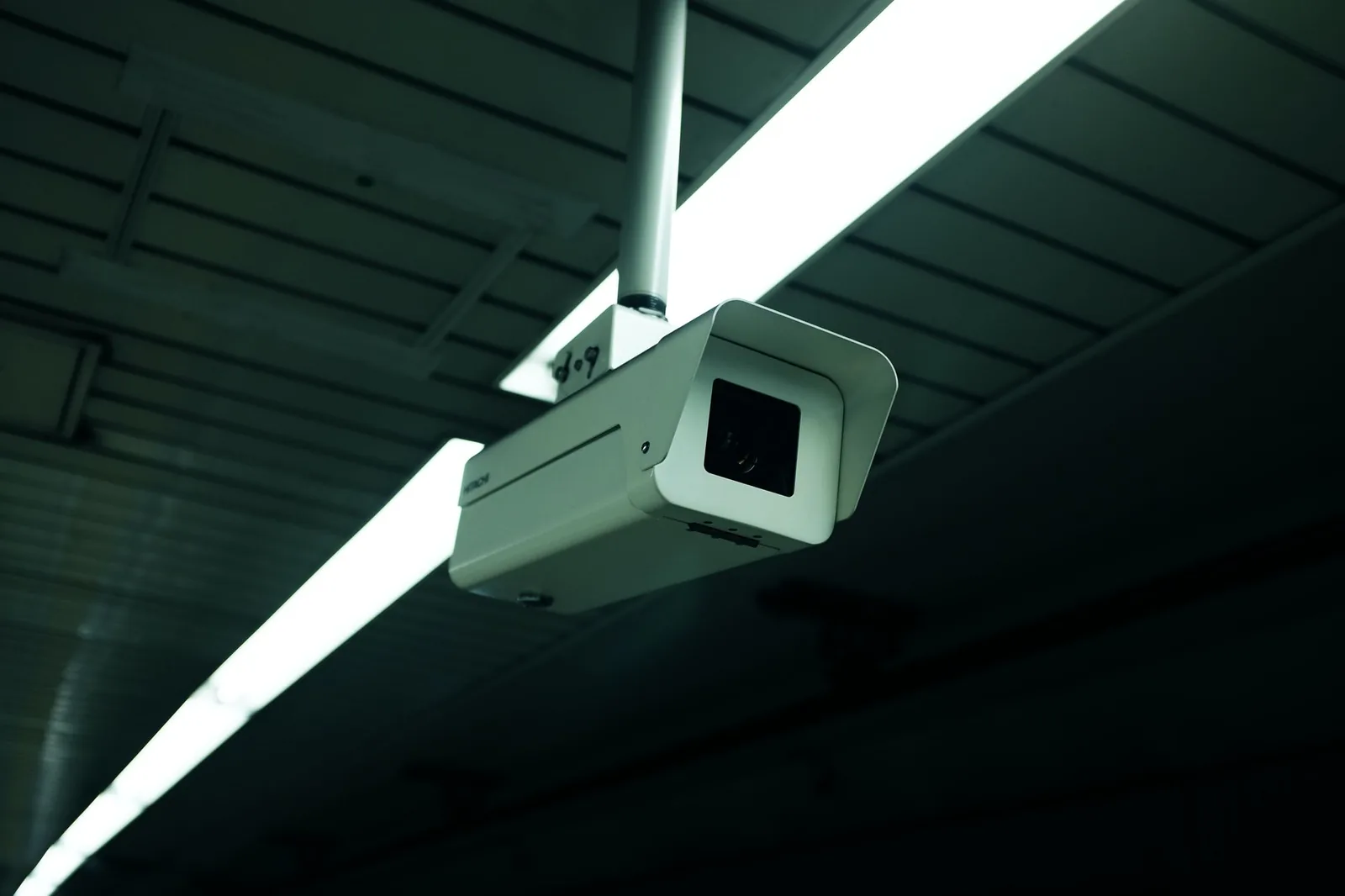 Ceiling-mounted CCTV in a retail-style interior